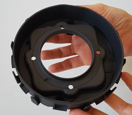 Carbon fiber-reinforced airbag housing, 3D-printed by Joyson Safety Systems using SLS technology.