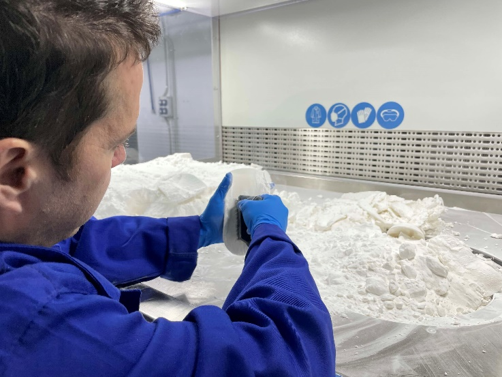 Technician at EdserLabs cleaning a 3D printed insole