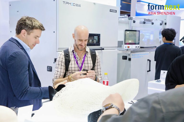 Visitors looking at 3D printed samples at TPM3D's booth at Formnext Asia Shenzhen 2025